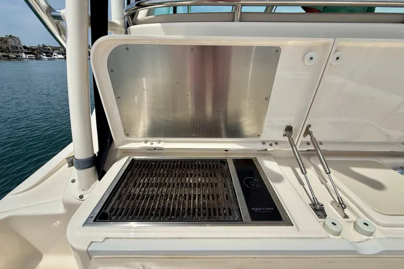 Slide: The Image of Outdoor grill on a 2012 Pursuit OS 345 Offshore boat, docked by the water. - 59
