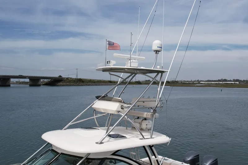 Slide: The Image of 2012 Pursuit OS 345 Offshore boat with radar and American flag on calm water. - 6
