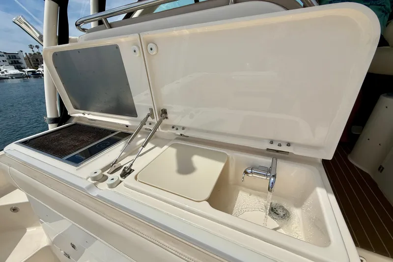 Slide: The Image of Outdoor kitchen on 2012 Pursuit OS 345 Offshore boat with sink and grill. - 60