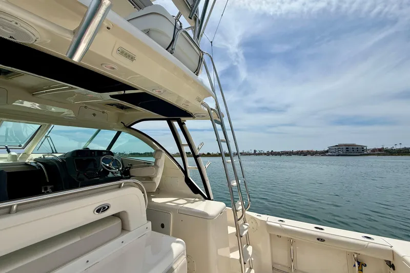 Slide: The Image of 2012 Pursuit OS 345 Offshore boat interior with ocean view and clear sky. - 70