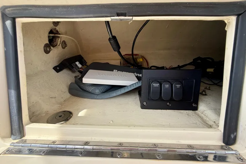 Slide: The Image of 2012 Pursuit OS 345 Offshore boat compartment with electronic controls and wiring. - 79