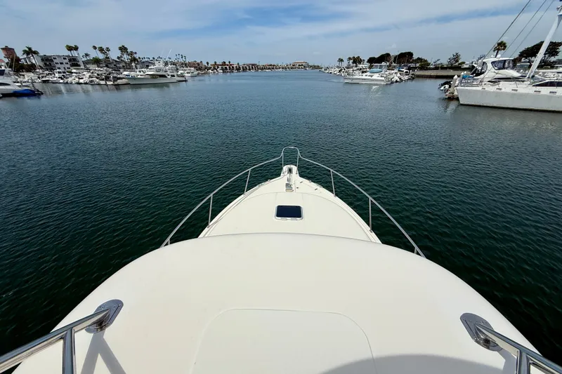 Slide: The Image of Bow view of 2012 Pursuit OS 345 Offshore yacht in a marina with calm waters. - 80