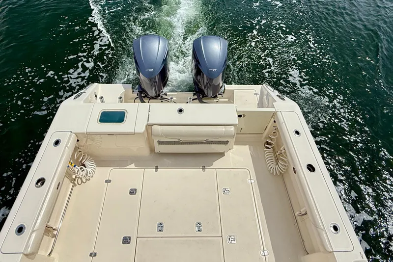 Slide: The Image of 2012 Pursuit OS 345 Offshore boat with dual engines cruising on water. - 81