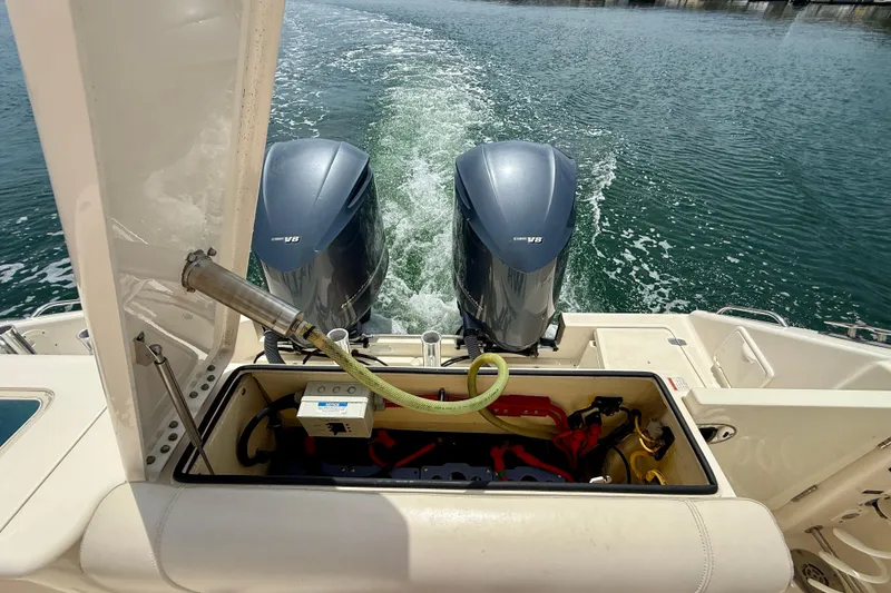Slide: The Image of 2012 Pursuit OS 345 Offshore boat with dual Yamaha V8 engines on water. - 84