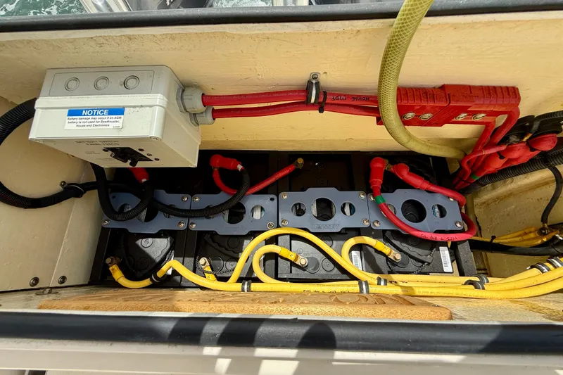 Slide: The Image of Electrical wiring and battery setup in a 2012 Pursuit OS 345 Offshore boat. - 85