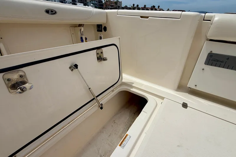 Slide: The Image of 2012 Pursuit OS 345 Offshore boat storage compartment with open hatch and hydraulic support. - 87