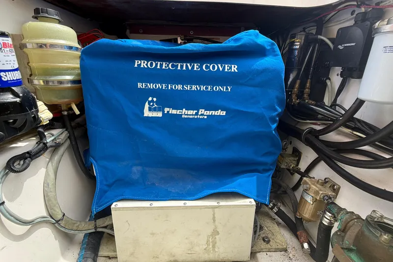 Slide: The Image of Engine compartment of 2012 Pursuit OS 345 Offshore with Fischer Panda generator cover. - 89