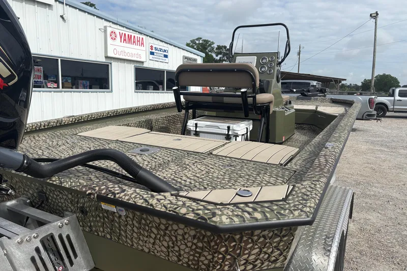 Slide: The Image of 2026 Vexus ACX 2210 boat with camouflage design, parked near Yamaha dealership. - 6