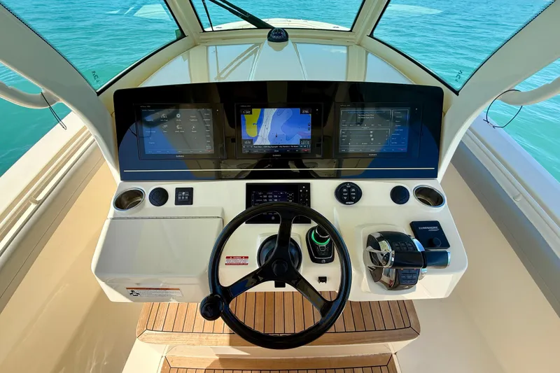 Slide: The Image of Helm of 2019 Scout 355 LXF boat with advanced navigation displays and controls. - 20
