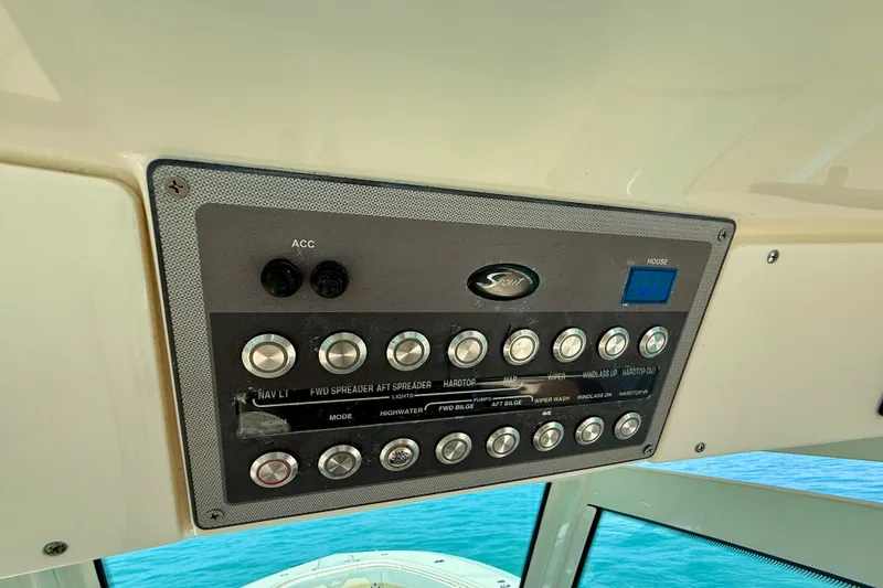 Slide: The Image of Control panel of a 2019 Scout 355 LXF boat with various switches and buttons. - 22