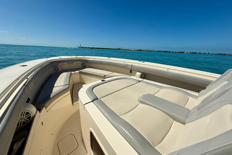 Slide: The Image of 2019 Scout 355 LXF boat interior with luxurious seating on open water. - 24