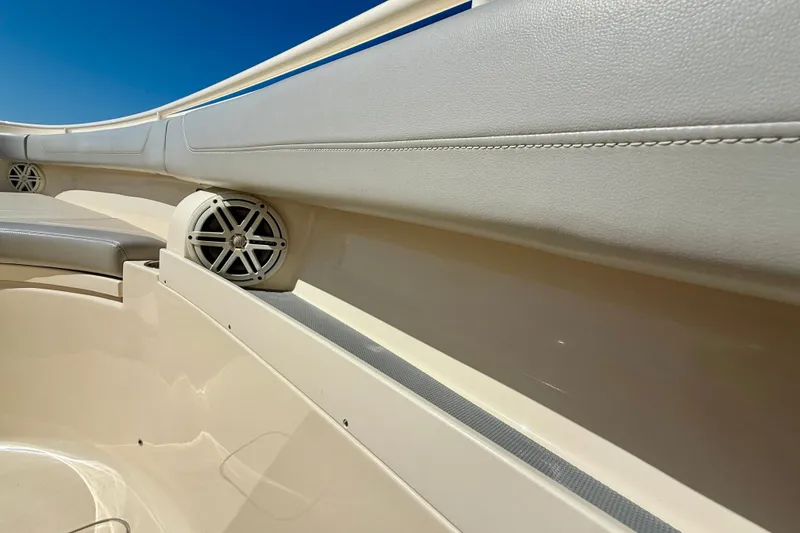 Slide: The Image of Interior view of 2019 Scout 355 LXF boat, featuring cushioned seating and built-in speakers. - 27