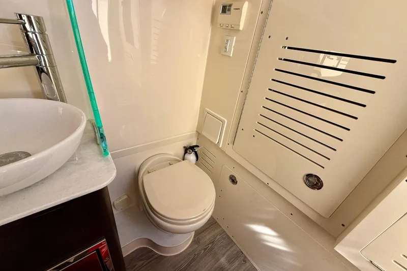Slide: The Image of 2019 Scout 355 LXF boat bathroom with modern sink and toilet. - 30