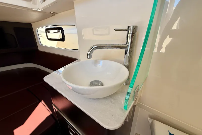 Slide: The Image of Luxurious interior of 2019 Scout 355 LXF boat featuring modern sink and faucet. - 31