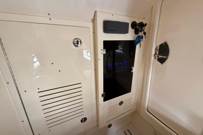 Slide: The Image of Interior view of a 2019 Scout 355 LXF boat showing control panel and keys. - 32