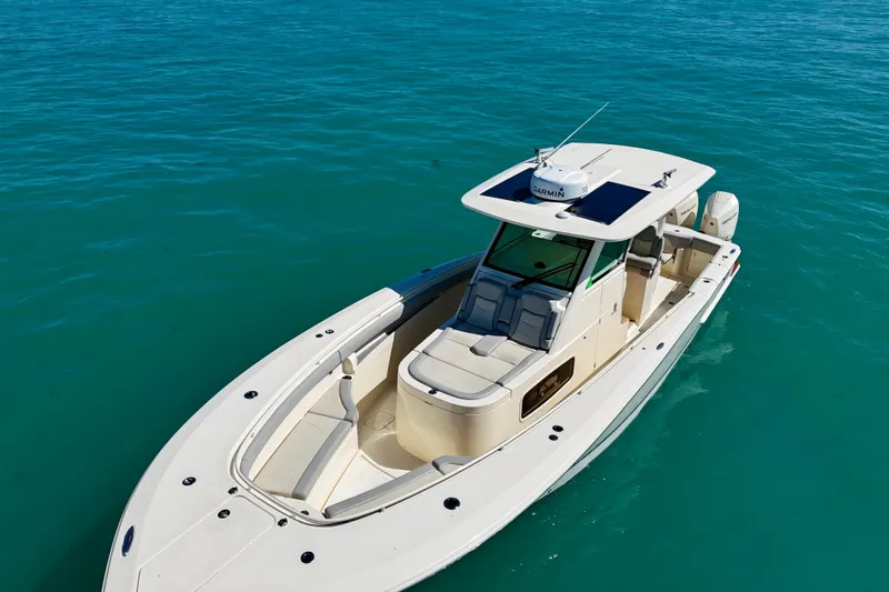 Slide: The Image of 2019 Scout 355 LXF boat on clear blue water, showcasing sleek design and luxury features. - 5