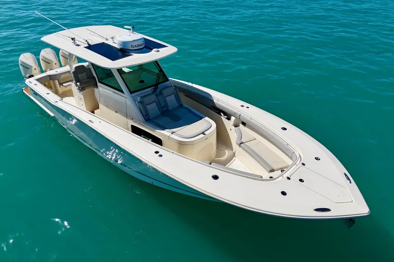 Slide: The Image of 2019 Scout 355 LXF boat on clear blue water, showcasing sleek design and triple engines. - 6
