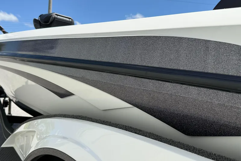 Slide: The Image of 2023 Ranger Z520C Cup-Equipped boat, sleek design with metallic accents, under clear blue sky. - 9