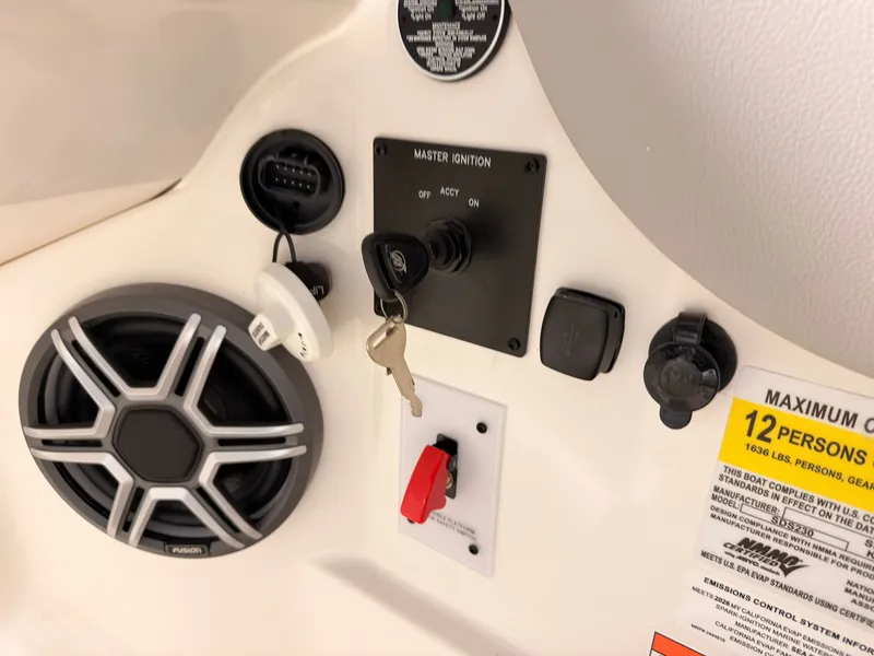 Slide: The Image of Close-up of a Sea Ray SDX 230 Surf control panel with ignition key and speaker. - 33