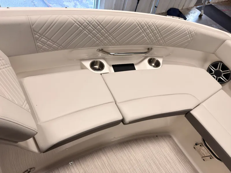 Slide: The Image of The 2026 Sea Ray SDX 230 Surf features an elegant, cushioned seating area with cup holders. - 45
