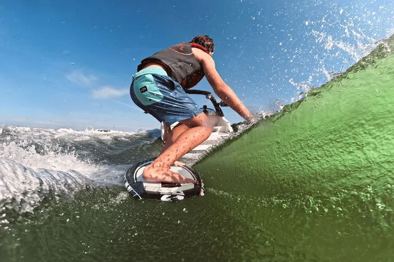 Slide: The Image of Surfer riding wave behind Sea Ray SDX 230 Surf 2026. - 10