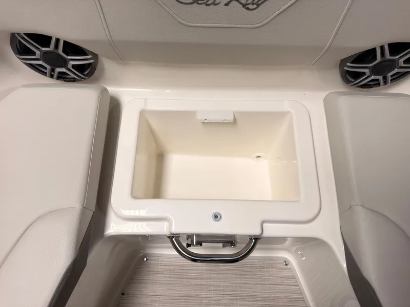 Slide: The Image of The image shows an open storage compartment on a Sea Ray SDX 230 Surf boat. - 48