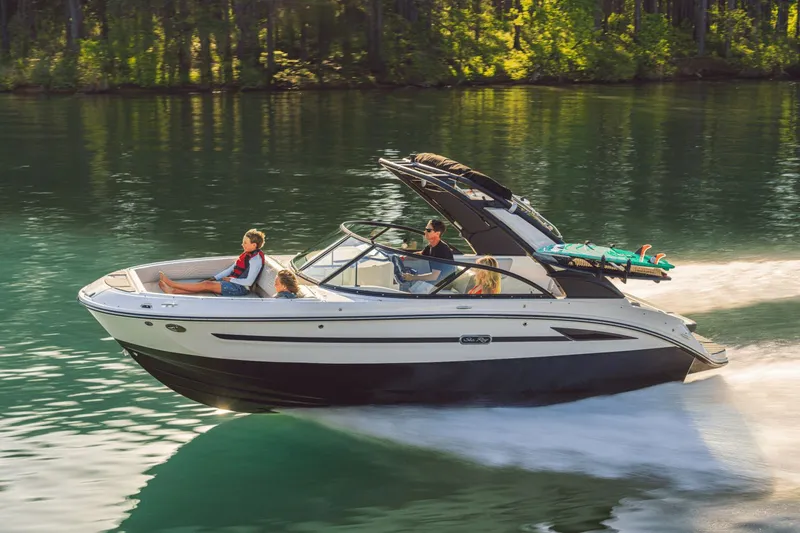 Slide: The Image of Sea Ray SDX 230 Surf 2026 cruising on a serene lake. - 21