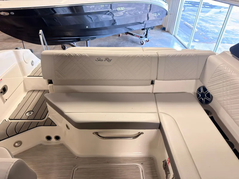 Slide: The Image of The 2026 Sea Ray SDX 230 Surf features an elegant white bench seat with quilted pattern. - 15