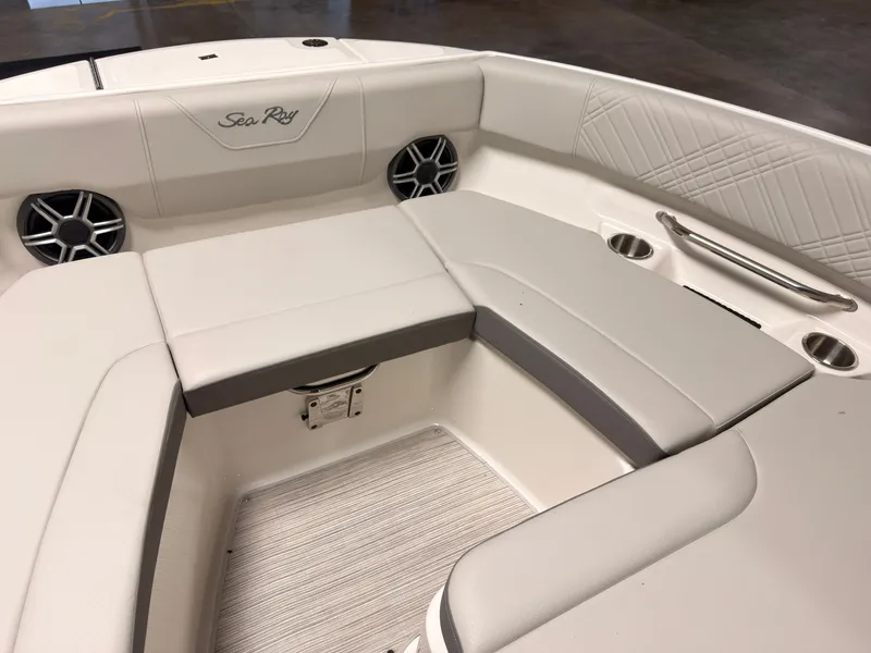 Slide: The Image of The image shows the bow area of a Sea Ray SDX 230 Surf boat with cushioned seating. - 47