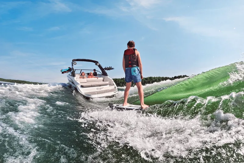Slide: The Image of Person surfing behind a Sea Ray SDX 230 Surf boat, 2026 model. - 31