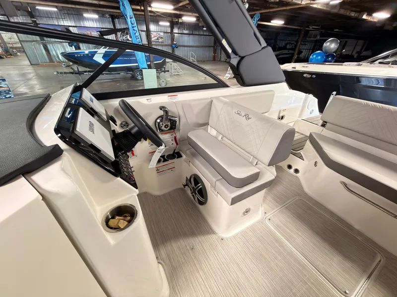 Slide: The Image of The image shows the cockpit of a 2026 Sea Ray SDX 230 Surf with modern controls. - 27