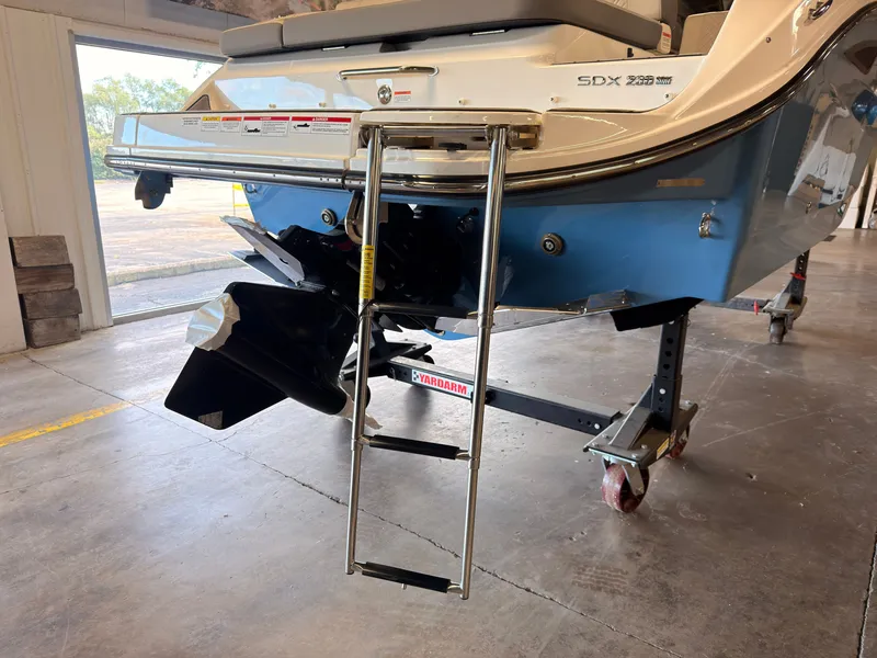 Slide: The Image of The 2026 Sea Ray SDX 230 Surf features a swim ladder and propeller at the stern. - 8