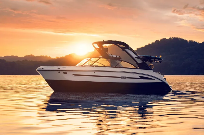 Slide: The Image of 2026 Sea Ray SDX 230 Surf boat at sunset on the water. - 43