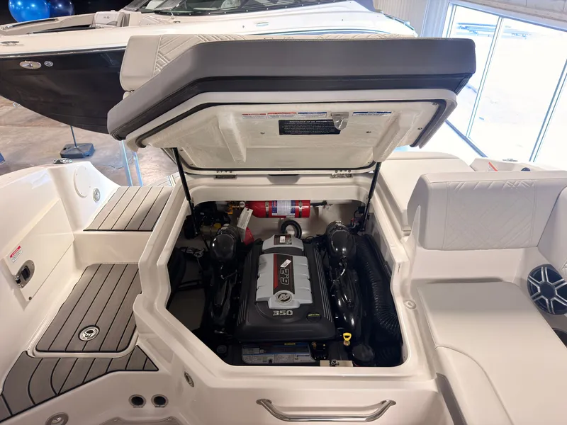Slide: The Image of The engine compartment of a 2026 Sea Ray SDX 230 Surf is open, revealing the engine. - 16