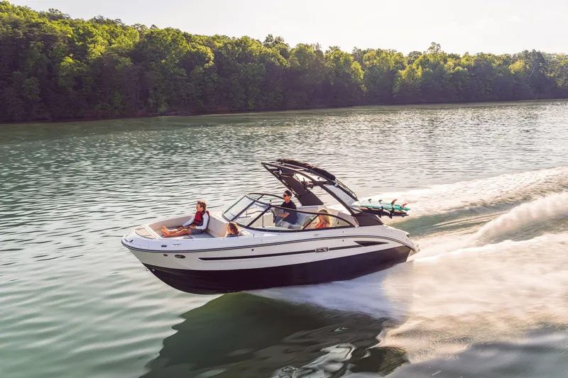 Slide: The Image of 2026 Sea Ray SDX 230 Surf cruising on a serene lake. - 45