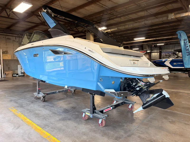 Slide: The Image of A 2026 Sea Ray SDX 230 Surf boat is on a dolly in a warehouse. - 4