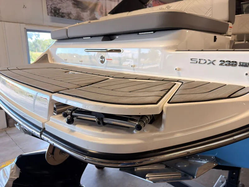 Slide: The Image of The image shows the rear of a 2026 Sea Ray SDX 230 Surf boat with a swim platform. - 7