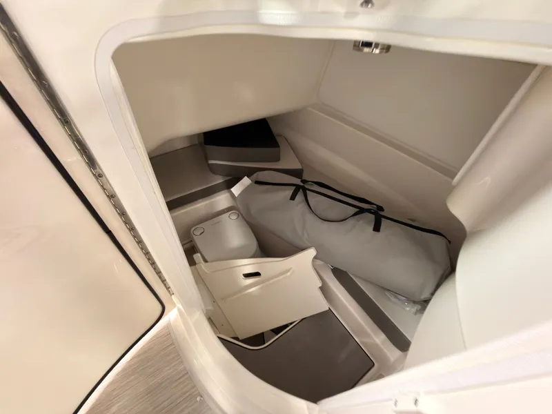 Slide: The Image of Interior of a Sea Ray SDX 230 Surf with storage space and a toilet. - 40