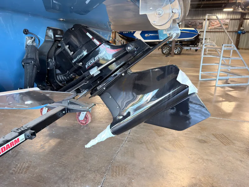 Slide: The Image of Close-up of a boat propeller in a workshop. The propeller is black and shiny. - 5