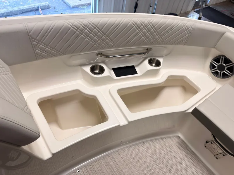 Slide: The Image of The image shows the interior of a 2026 Sea Ray SDX 230 Surf boat with elegant detailing. - 46