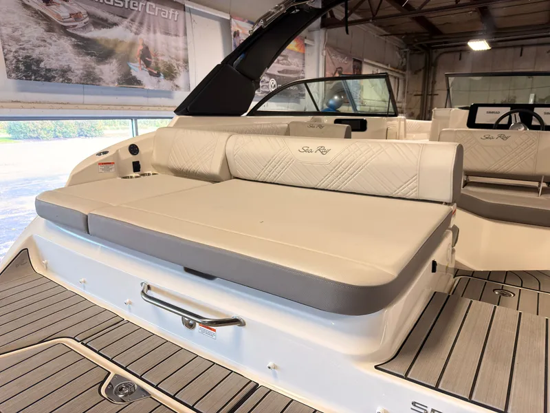 Slide: The Image of The image shows the spacious aft deck of a Sea Ray SDX 230 Surf with comfortable seating. - 11