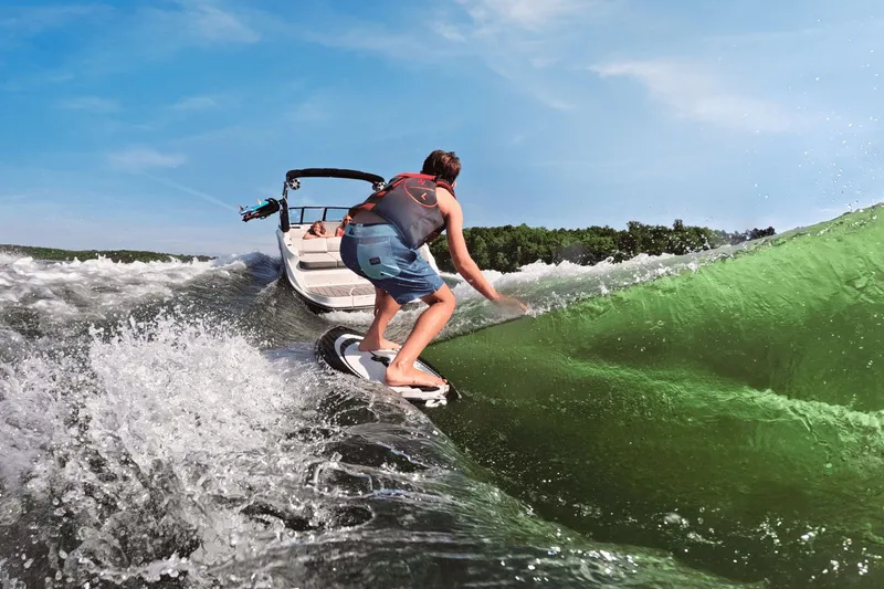 Slide: The Image of Surfer behind 2026 Sea Ray SDX 230 Surf on green wave. - 8