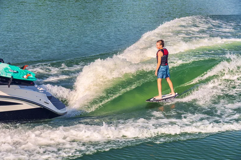 Slide: The Image of Surfer behind Sea Ray SDX 230 Surf 2026 on wave. - 9