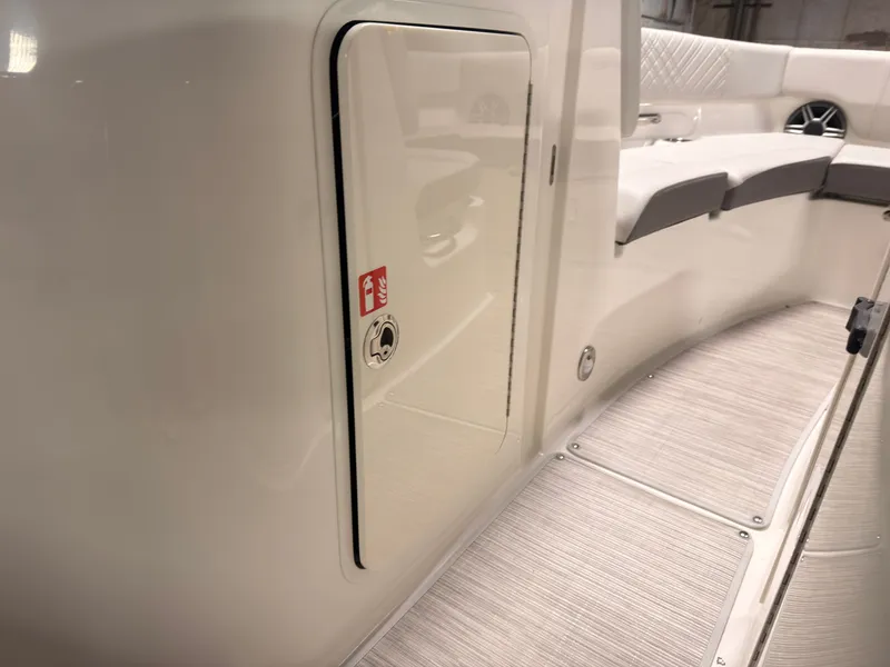 Slide: The Image of Interior of a Sea Ray SDX 230 Surf with white and gray seating and a storage compartment. - 42