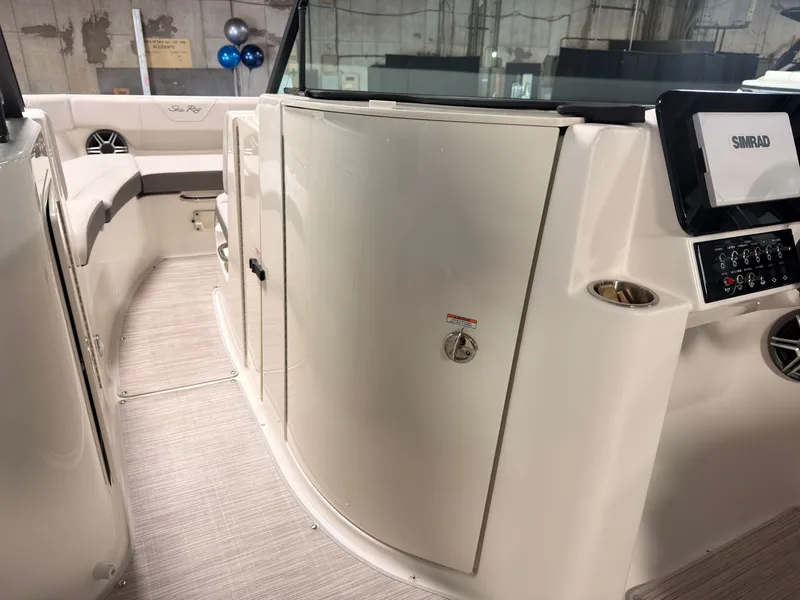 Slide: The Image of Interior of a 2026 Sea Ray SDX 230 Surf with sleek seating and modern electronics. - 38
