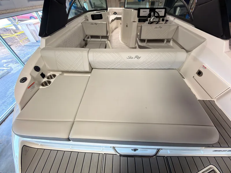 Slide: The Image of The image shows the cockpit of a 2026 Sea Ray SDX 230 Surf boat with sleek seating. - 12