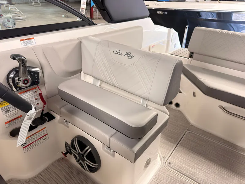 Slide: The Image of Interior of a Sea Ray SDX 230 Surf with beige upholstered seat and control console. - 28