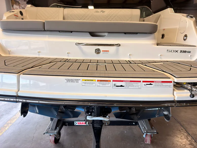 Slide: The Image of The image shows the rear of a 2026 Sea Ray SDX 230 Surf boat with a spacious swim platform. - 9
