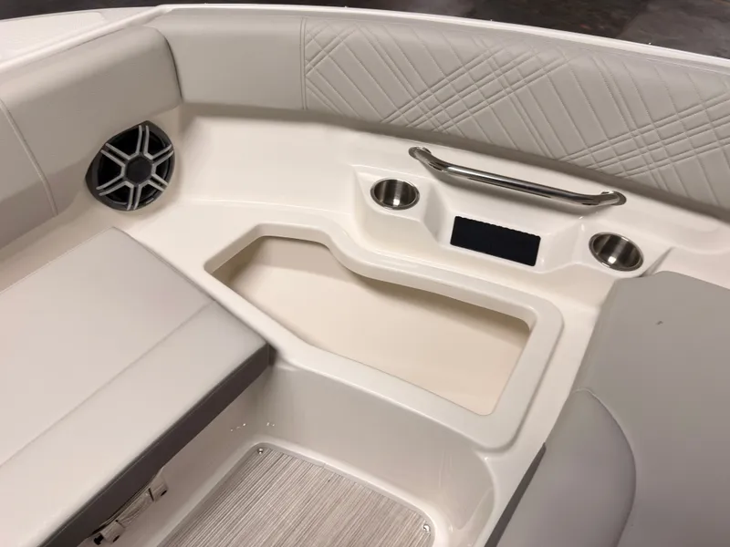 Slide: The Image of The image shows the interior of a 2026 Sea Ray SDX 230 Surf boat with sleek upholstery. - 49