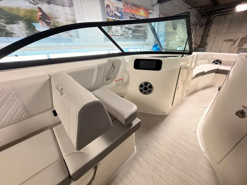Slide: The Image of Interior view of a Sea Ray SDX 230 Surf boat with white seating and a modern dashboard. - 22
